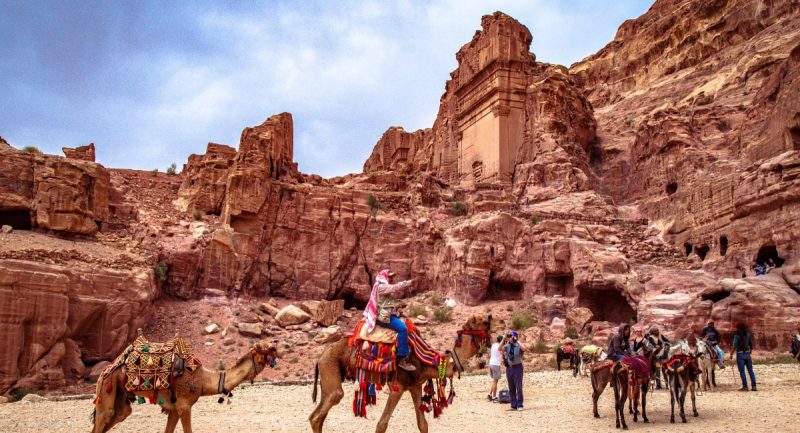 Βεδουίνοι που κάνουν βόλτες με τις καμήλες τους στα αρχαία ερείπια της Πέτρας.